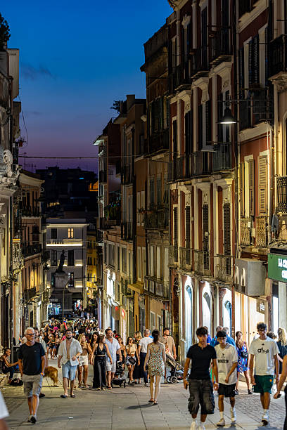 Cagliari, Sardinia, Italy Aug 8, 2025 People walking at night on Via Giuseppe Manno in the historic downtown.
