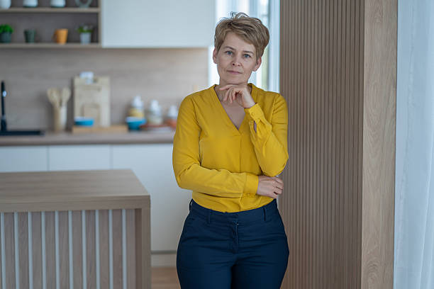 istock Confident mature businesswoman posing in modern kitchen interior 2235275718