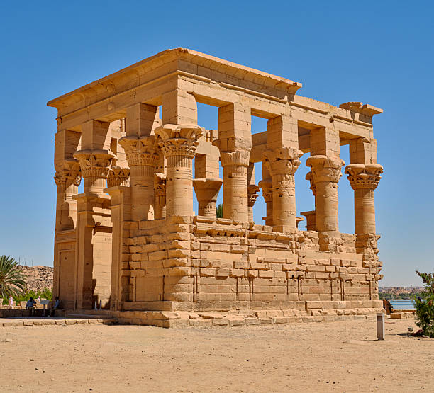 istock Ancient Egyptian Temple on the Nile River Surrounded by Clear Sky and Sandy Desert 2235276056
