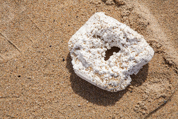 large piece of deteriorated Styrofoam on the beach background