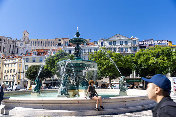 Lisbon, Portugal - September 25, 2022: Fountain Rossio Square in Lisbon, in Portugal. Tourist on the background.