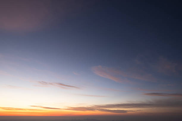 At sunrise, the sky and the colorful clouds.