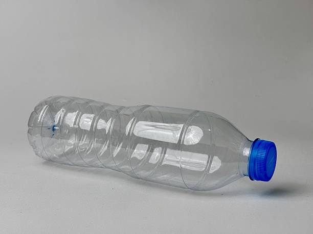 istock Translucent Pet Bottle With Blue Cap Laying Horizontally Offering Versatility for Mockups and Compositions Emphasizing Recycling Reduction and Clean Water Resources On a Plain Background 2235291055