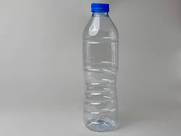 istock Empty clear plastic water bottle with blue cap isolated against neutral background for recycling awareness sustainability environmental responsibility beverage container health promotion design 2235291266
