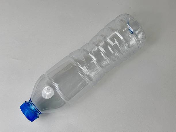 istock Reusable clear plastic bottle with blue cap on neutral background showcasing sustainability, ecological awareness, and the importance of recycling for environmental conservation 2235291273