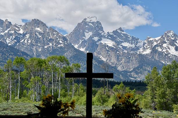 istock mountains in the background with a cross in the foreground 2235292826