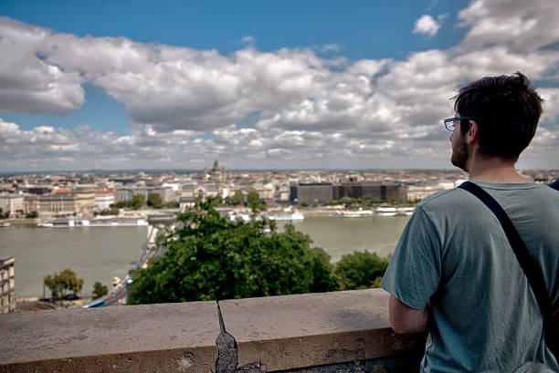 Budapest, Hungary – July 28, 2025: A tourist enjoys panoramic views over the Danube River and Pest skyline from the Buda side of the city.