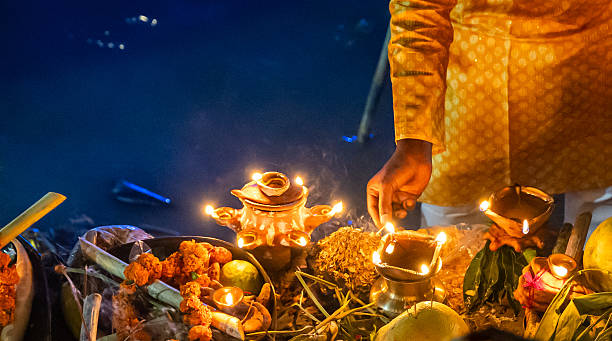 istock devotee glowing traditional oil lamp offering on chhath puja prayer at riverbank 2235292978