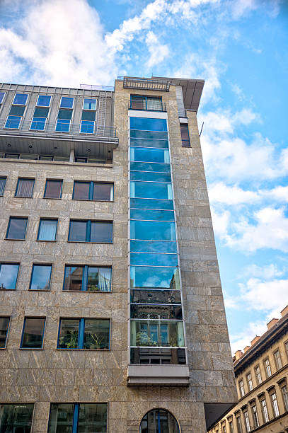 istock Exterior view of a modern office building with a central glass window feature in downtown Budapest 2235293087