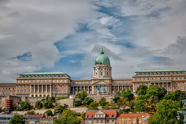 The Széchenyi Chain Bridge was built in 1849. It spans the river Danube between Buda and Pest, the western and eastern sides of Budapest.  It is a suspension bridge.\nThe bridge is 'guarded' by statues of lions. The Széchenyi Chain Bridge was built in 1849. It spans the river Danube between Buda and Pest, the western and eastern sides of Budapest.  It is a suspension bridge.\nThe bridge is 'guarded' by statues of lions.\nIn the background one sees the Buda Castle or the Budavári Palota. This is the historical castle and palace complex of the Hungarian kings in Budapest.