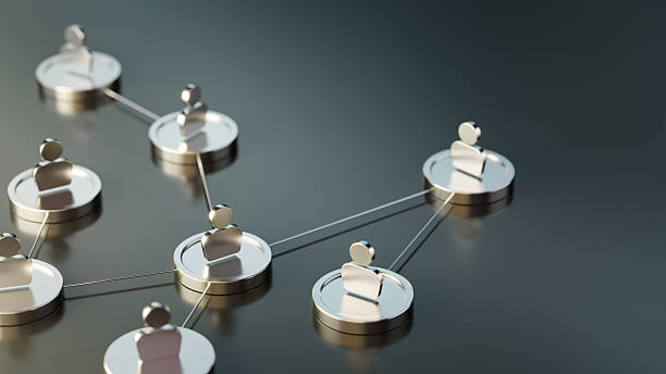 Metallic figures with an abstract human resources symbol connected by thin lines symbolising networking, teamwork, and relationships. The structure represents collaboration and communication within systems, emphasising connection within an abstract framework.
