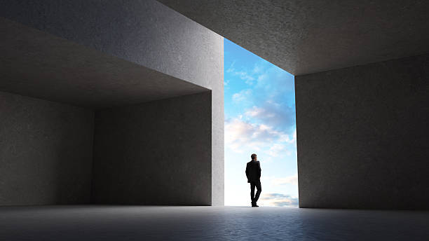 istock Silhouetted Man in Modern Architecture with Blue Sky Background 2235294261