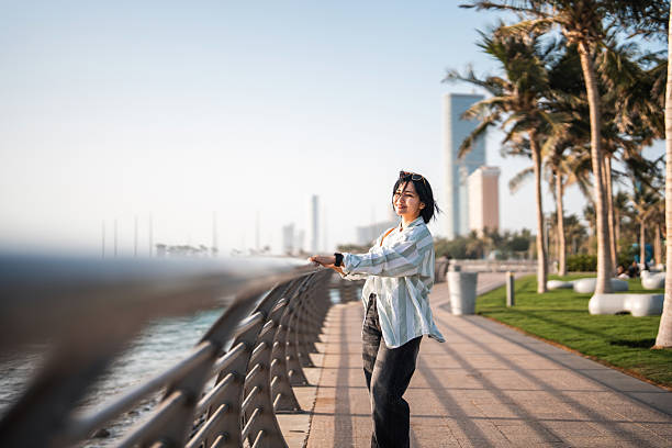 istock Mid Adult Asian Individual Enjoying Leisure Walk on Corniche 2235298041