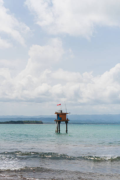 Early warning system station in middle of sea. Tsunami, high water and low water automated detection for casualties prevention and safety. Sunny weather.