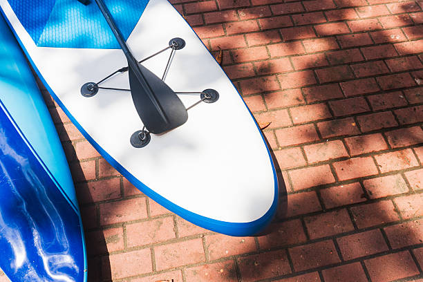 istock A close-up of two paddleboards resting on a red brick ground 2235300205