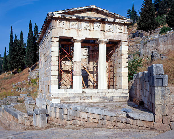 The Treasury of the Athenians at the archaeological site of Delphi, Greece, a small stone building built to house offerings from Athens to the sanctuary of Apollo.