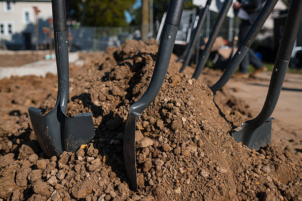 Metal shovels in dirt for groundbreaking ceremony for new construction build
