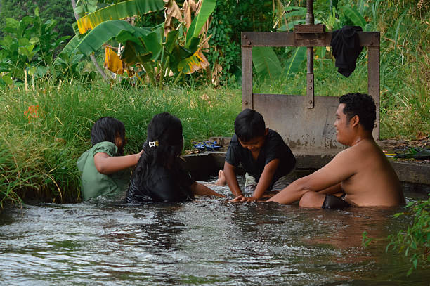 istock Parents hold hands creating barrier as son tries to pass in stream 2235302888
