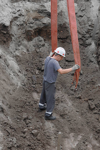 istock Asian male worker in construction site handling equipment safely 2235304381