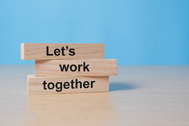 istock Wooden blocks with words 'Let's work together'. Business concept 2235307220