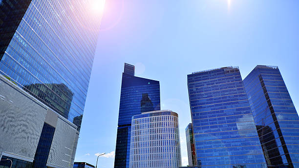 istock Downtown corporate business district architecture. Glass reflective office buildings against blue sky and sun light. 2235308326