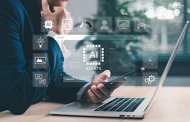 istock Businessman using laptop and smartphone with AI agents holographic interface. Artificial intelligence for automation, chatbots, data analytics and digital transformation in smart business. 2235308793