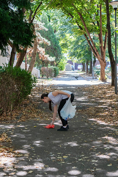istock Young woman plogging run 2235312133