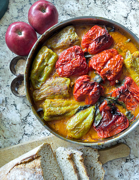 Rustic Stuffed Green Red Bell Peppers with Tomato Sauce and Crusty Artisan Bread, Apples, Traditional Mediterranean Cuisine
