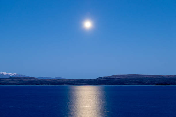 A full moon rises over Lake Pukaki in the southern alps of the South Island.  This image was achieved with a 3.2 second exposure and taken from a scenic lookout on Mt Cook Road on a cold evening shortly before sunset on 7 September 2025.