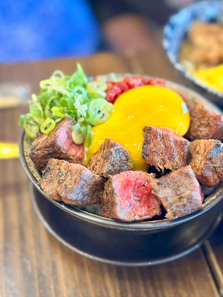 Grilled beef rice bowl with raw egg yolk