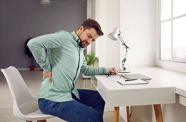 istock Exhausted man feeling pain in back suffering from lower lumbar backache 2235318820