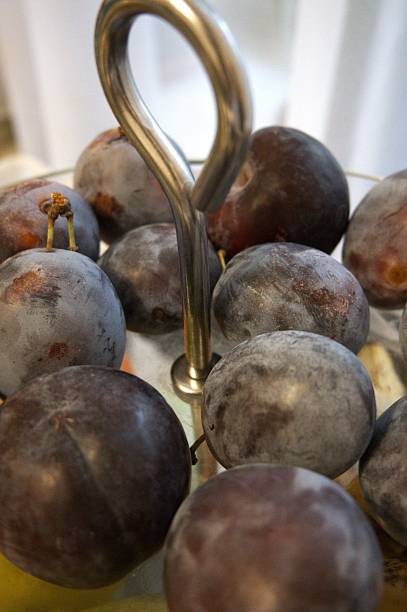 istock Fresh ripe plums in glass serving bowl, close-up 2235319879