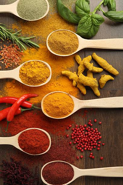 istock Different aromatic spices and herbs on wooden table, flat lay 2235321447