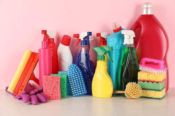 istock Different cleaning products and supplies on table against pink background 2235321832