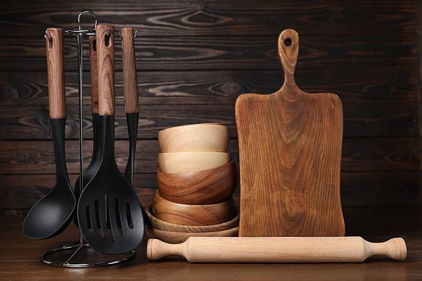 istock Dishware and cooking utensils on wooden table 2235322927