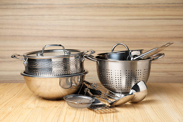 istock Dishware and cooking utensils on wooden table 2235323017