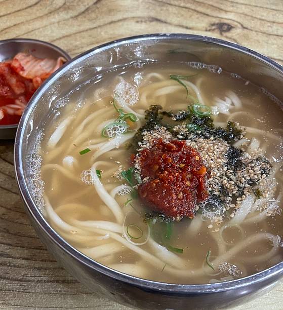 Warm and comforting kalguksu with hand-cut noodles in rich, savory broth, served with vegetables and sometimes seafood or chicken