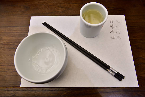 Classic blue pattern rice bowl with wooden chopsticks isolated against white.