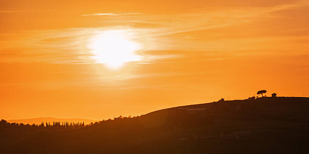 Tuscany hill silhouette during a spring sunset, Siena province, Italy