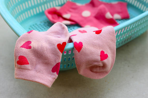Colorful socks with heart  in a laundry basket.
