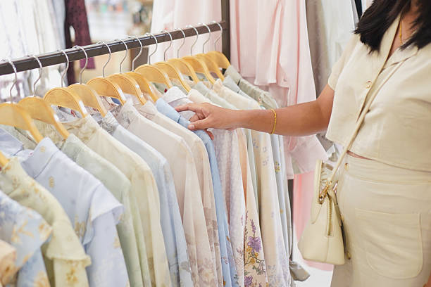 istock Woman’s Hand Choosing Pastel Clothes 2235326437