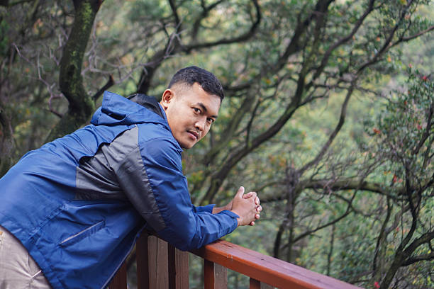 istock Male Traveler Smiling in Forest 2235327579