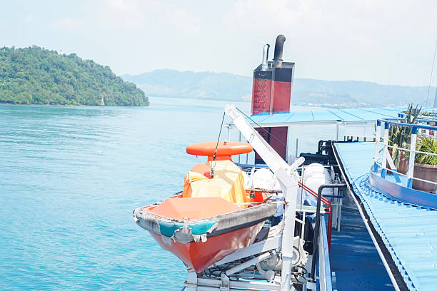 Bright orange emergency boat secured for marine safety.