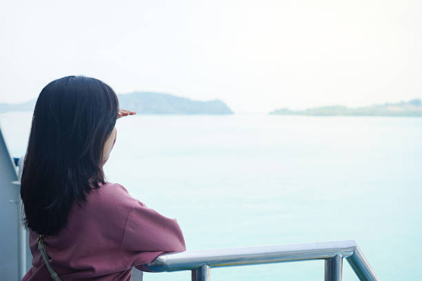 istock Female traveler standing on ferry deck 2235329311