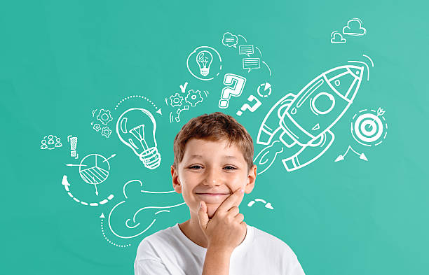 istock Smiling boy thinking with creative concept drawings of rocket, l 2235335524