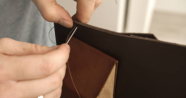 istock Leather flap stitching by hand on brown wallet 2235336810