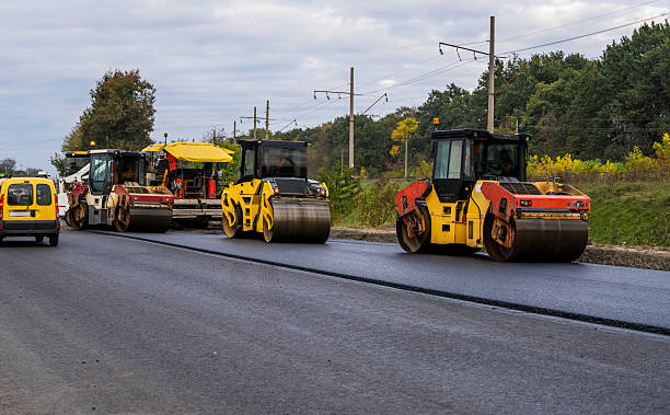 istock Heavy Asphalt Road Roller with Heavy Vibration Roller Compactor and Asphalt Pavers laying new asphalt on the roadway on a road construction site. 2235337275