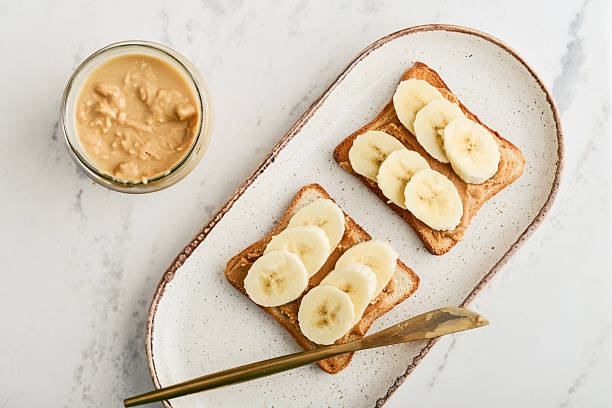istock Peanut butter sandwich with fresh banana slices 2235338820