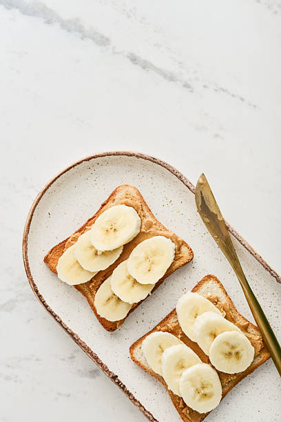 istock Peanut butter sandwich with fresh banana slices 2235338823