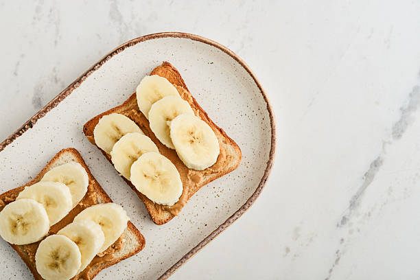 istock Peanut butter sandwich with fresh banana slices 2235338824